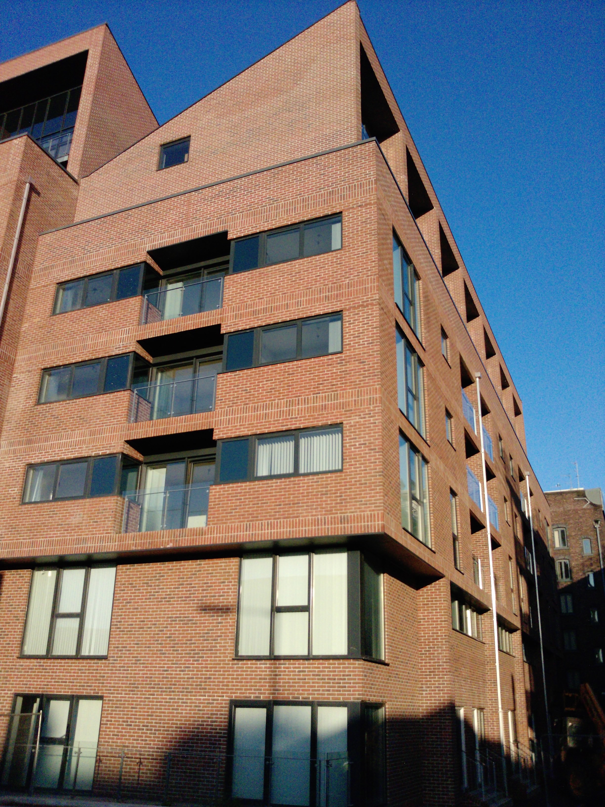 Site photograph — corner elevation and penthouse tiers